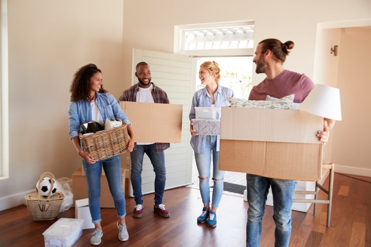 friends-help-couple-to-carry-boxes-into-new-home-on-moving-day.jpg